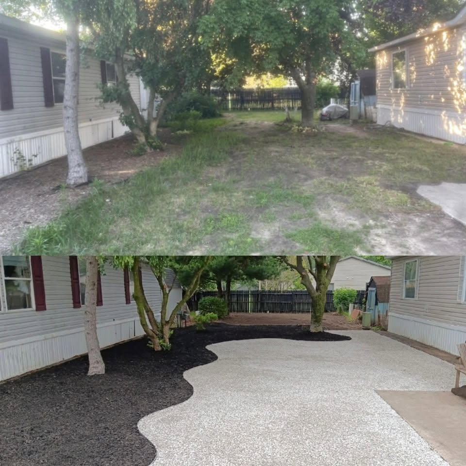 Backyard transformed with decorative stone and mulch beds in Holland, Michigan
